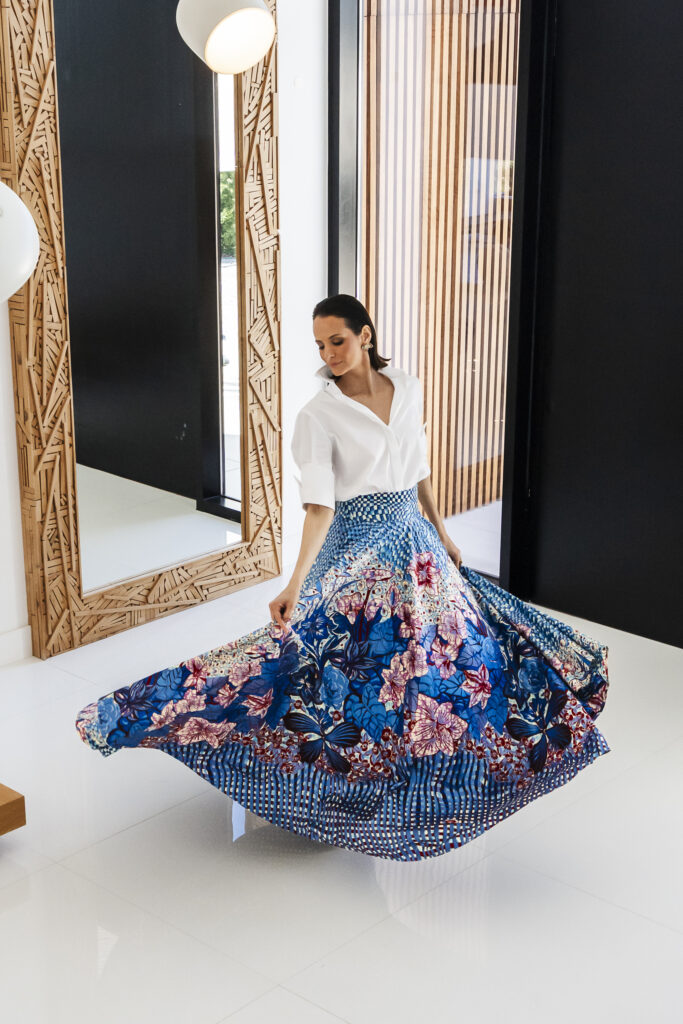 A Decade of Design: Roselyn Silva on Intentional Elegance and Her São Tomé Roots 3 A model twirling in a blue and cream floral skirt from the Roselyn Silva Legacy collection