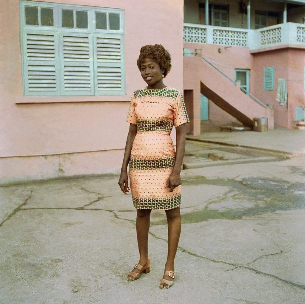 A James Barnor photograph of Ghanaians dressed in elegant custom clothing, capturing the spirit of mid-20th-century celebrations.