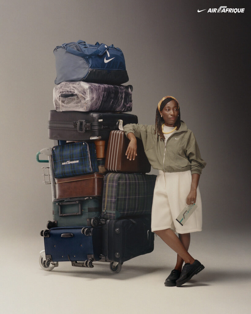 Person leaning against stacked luggage.