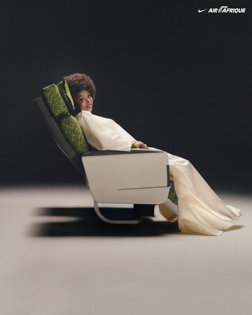 Person seated in stylish airplane chair.