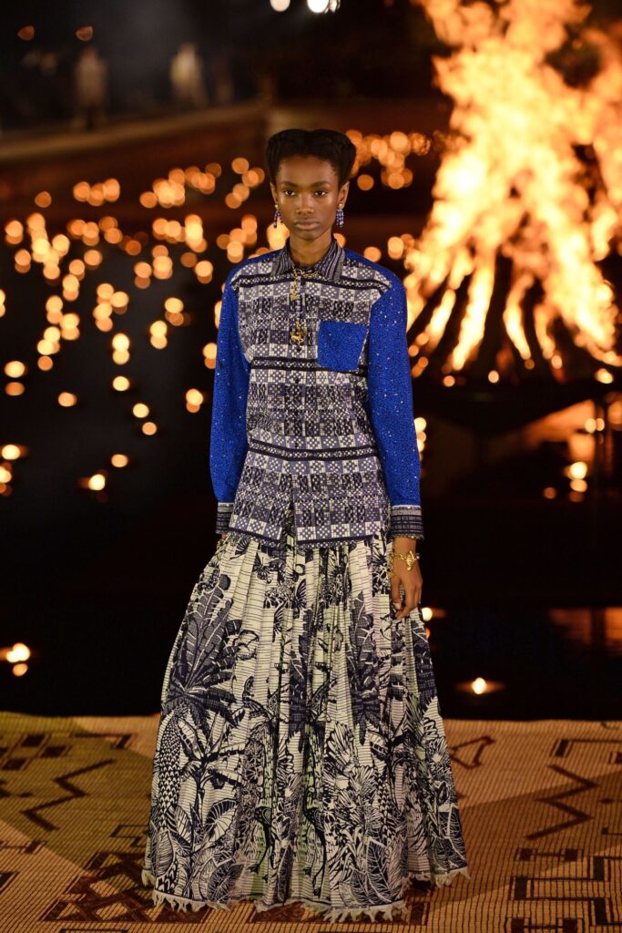 Model in vibrant patterned outfit.