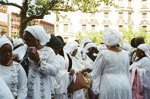 People in white attire celebrating together.