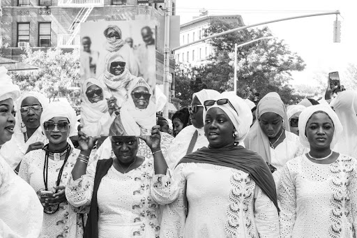Crowd in white attire celebrating together.