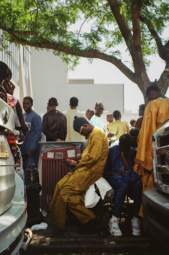 People gathered near a dumpster.