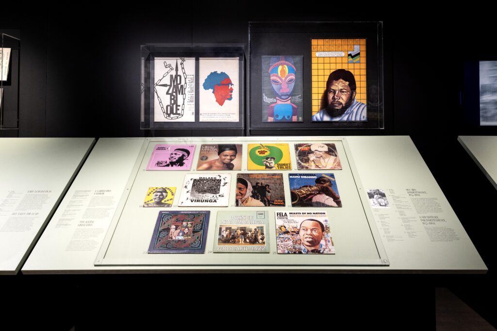 Africa Fashion Arrives in Montreal: A Global Conversation Continues 4 Close-up of display cases featuring album covers, posters, and artwork of African liberation leaders and musicians from the 1960s–1980s.