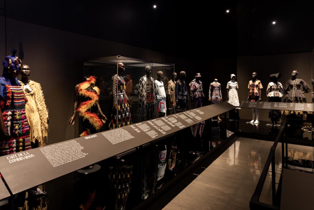 Africa Fashion Arrives in Montreal: A Global Conversation Continues 7 Long row of mannequins showcasing vibrant, textured garments illustrating the theme L’art de la combinaison / The Art of Combination.