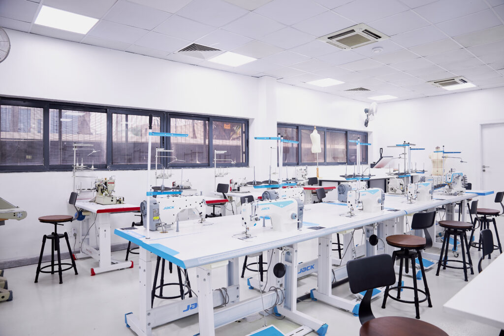 Ananse Center for Design Opens in Lagos: A New Integrated Hub for African Creatives 2 Cloth sampling studio at the Ananse Center for Design, with long work tables, stools and machines