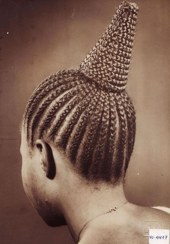 Close-up of a Nigerian woman wearing an intricately braided cone-shaped hairstyle documented by photographer J.D. ’Okhai Ojeikere, part of his Hairstyles series (1968–1993), celebrating Yoruba hair artistry and cultural expression.