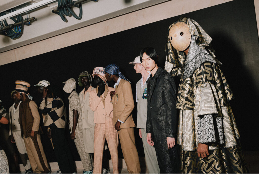 African Ritual Aesthetics in the Age of Luxury Fashion 5 Models lined up in tailored and printed looks with sculptural headpieces, Labrum London's SS23 Freedom of Movement
