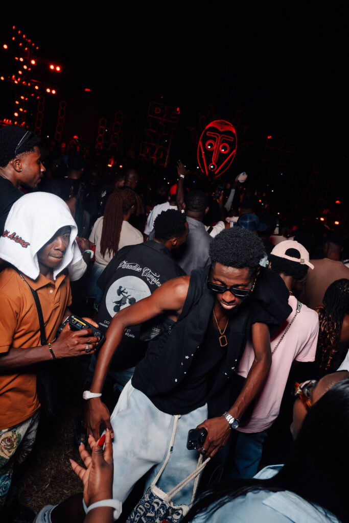 Young people packed together at a night-time event in Accra