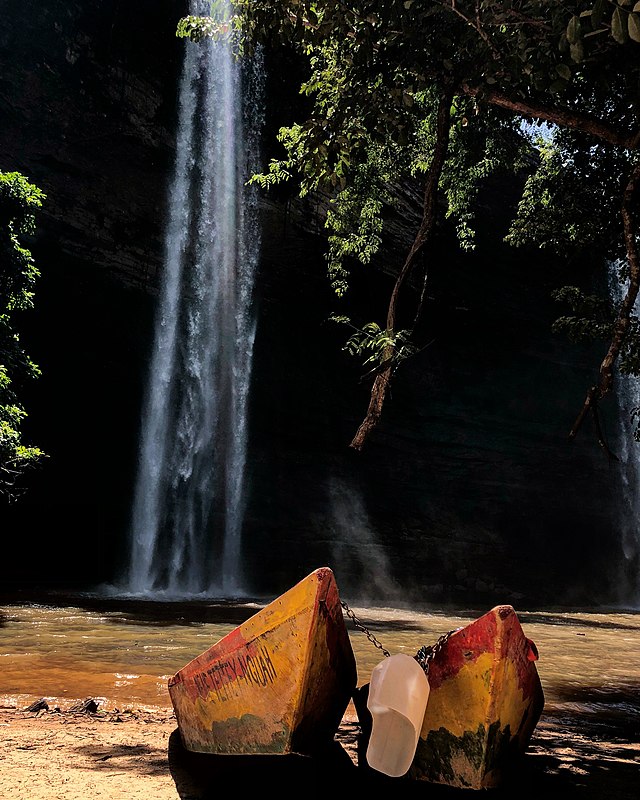 The Best Places to Propose in Africa: From Cape Town to Marrakech 8 Close-up of two colorful, rustic wooden boats chained together on a riverbed at the base of Boti Falls in Ghana.
