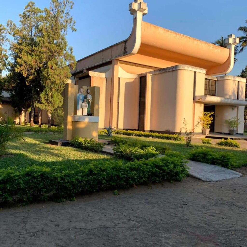 Modernist church with angular geometric forms in golden and red tones. Igreja da Sagrada Família da Machava by Pancho Guedes, 1960–64, Machava, Mozambique. 