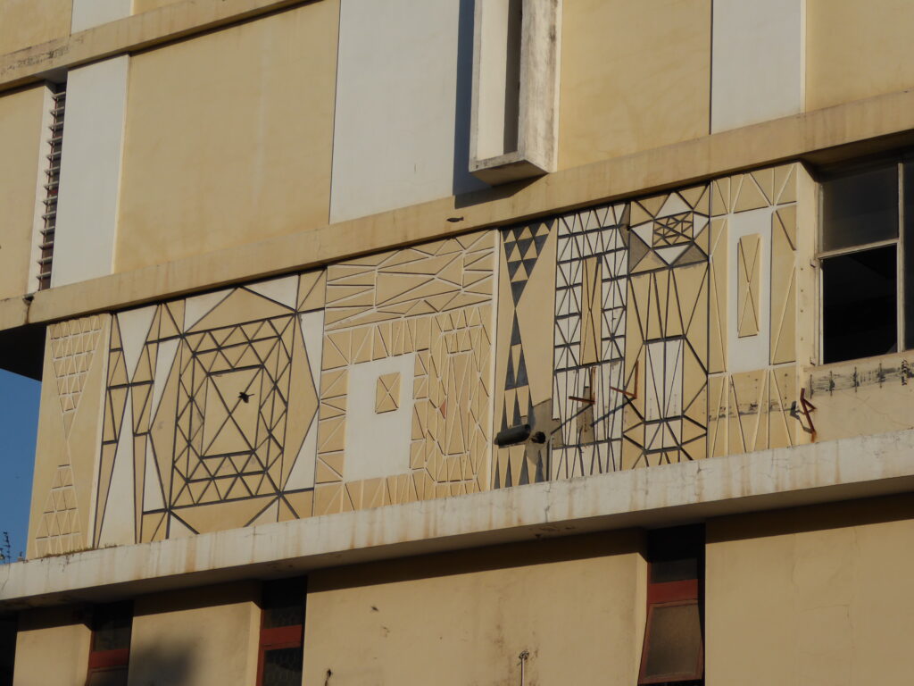 Geometric mural pattern on facade of Edifício Tonelli by Pancho Guedes, 1954–58, near Tunduru Botanical Garden, Maputo, Mozambique. Patterns compared to Mapogga designs.