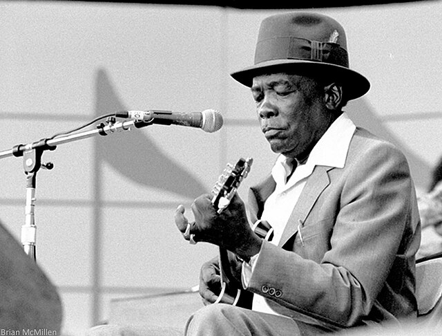 The Blues That Never Left Africa 2 John Lee Hooker performing at outdoor concert in 1981, photographed by Brian McMillen