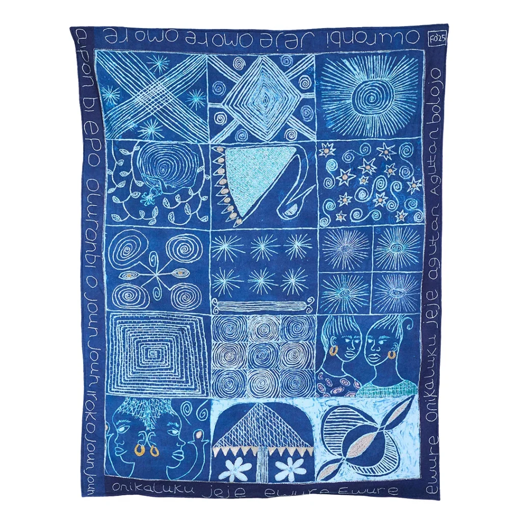 Three African Knowledge Systems on the Loewe Craft Prize 2026 Shortlist 2 Hand-embroidered and beaded quilt by Fadekemi Ogunsanya using Adire Eleko resist-dyeing technique with indigo, Yoruba script, and cassava starch patterns across fifteen segments.