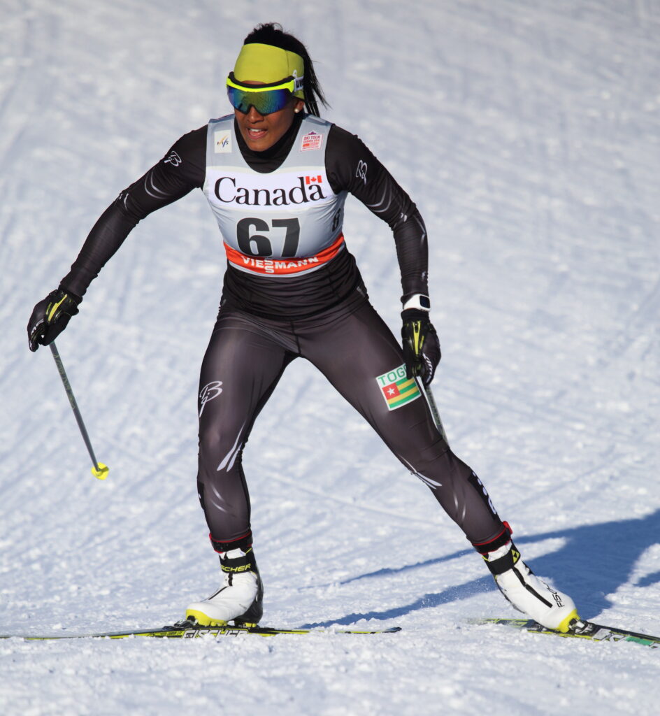Cross-country skier Mathilde-Amivi Petitjean racing in a black suit with race bib 61
