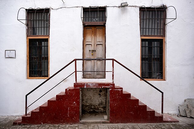 The Best Places to Propose in Africa: From Cape Town to Marrakech 5 Red steps leading to a carved wooden door on a whitewashed building in Stone Town, Zanzibar