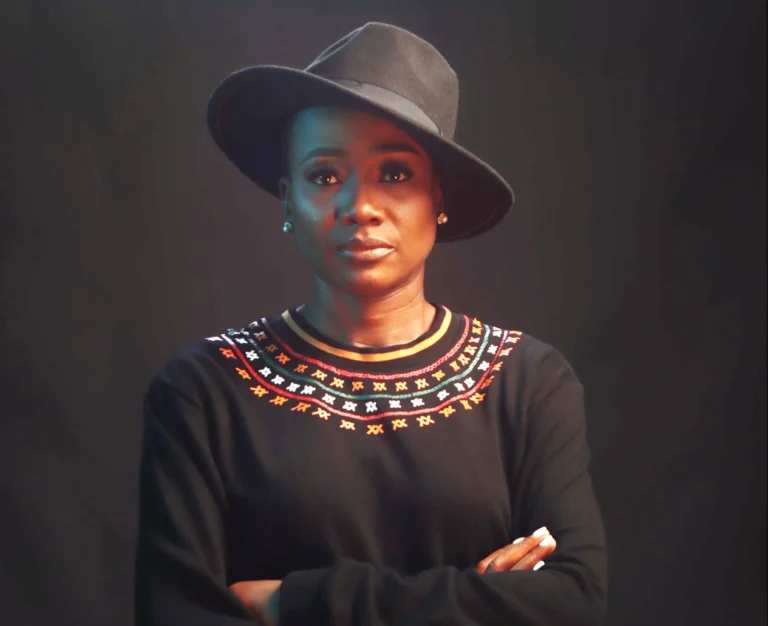 Kibonen Nfi, founder of KIBONEN wearing hat and sweater.
