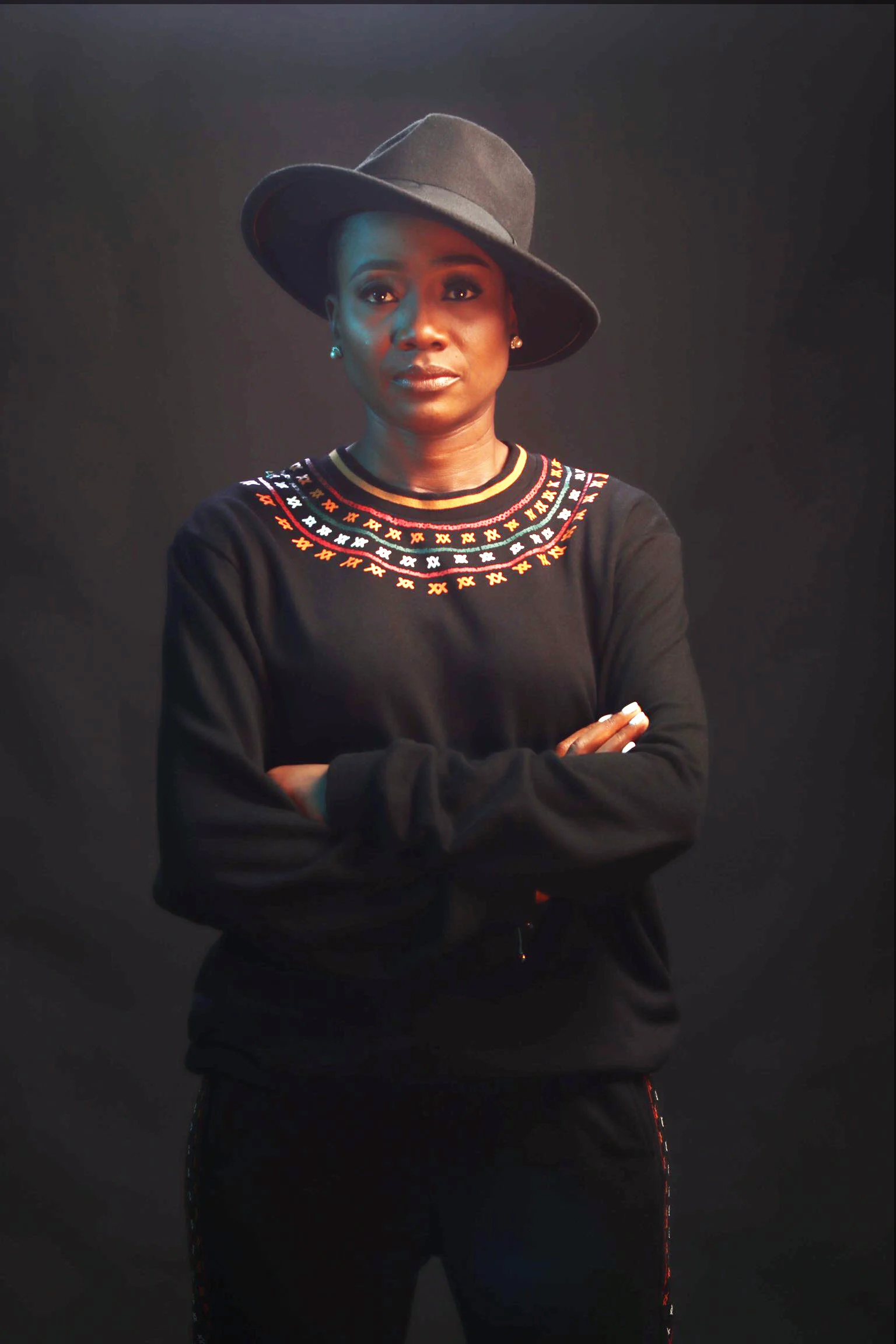 Person in black outfit and hat