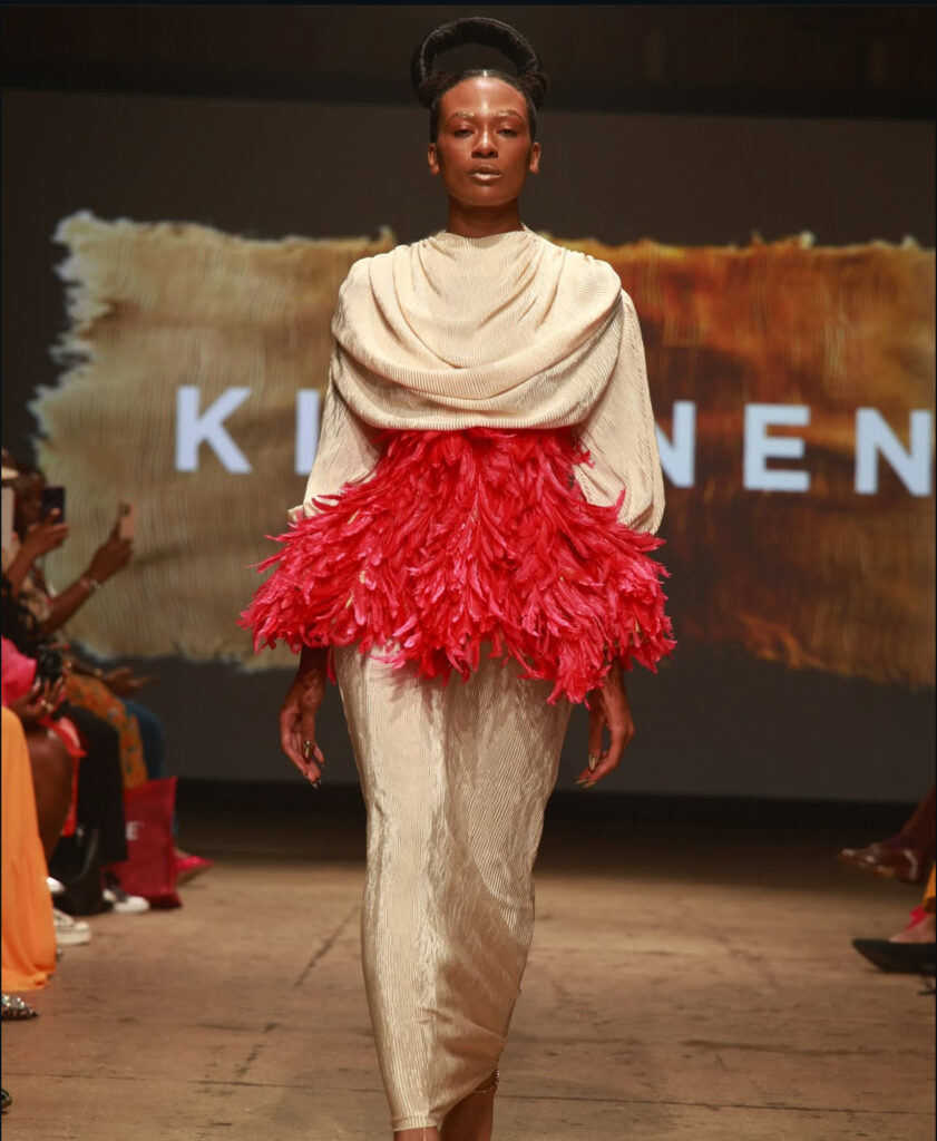 Kibonen and the Business of Cultural Authority 2 Model wearing vibrant feathered dress