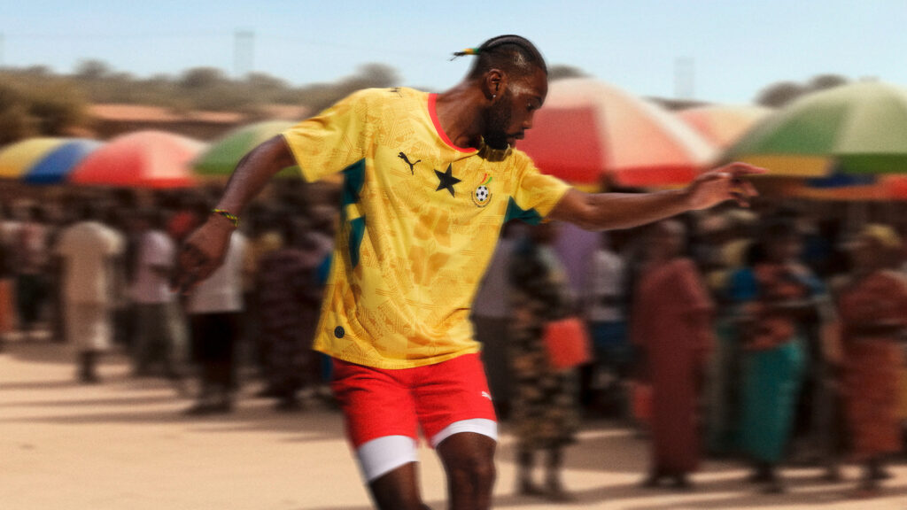 Model wearing the yellow PUMA Ghana national football team away kit for the 2026 World Cup