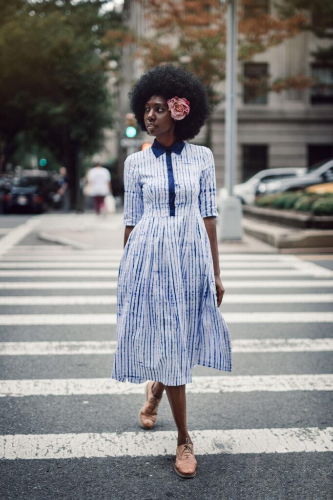 Mariama Camara wearing Guinean indigo tie-dye dress crossing a New York City street