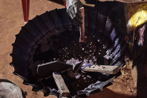 Material Literacy: The Knowledge in Cloth 2 Close-up of indigo dye bath being stirred in Kindia, Republic of Guinea