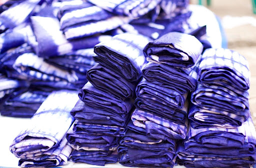 Material Literacy: The Knowledge in Cloth 3 Folded pieces of Guinean cotton indigo tie-dye textiles manufactured for the Tory Burch collaboration.