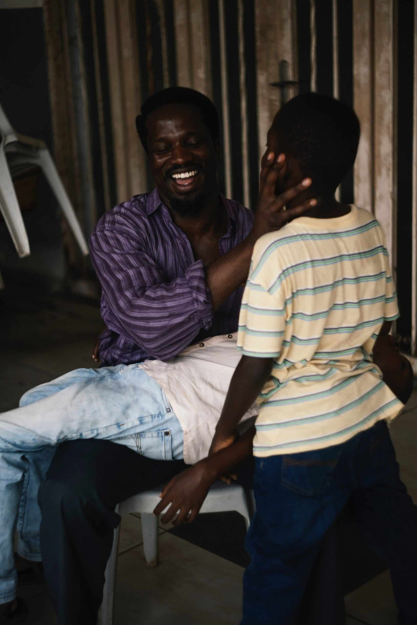 A cinematic still from My Father’s Shadow showing a close-up of a character, capturing the film's themes of memory and grief in a Nigerian household.