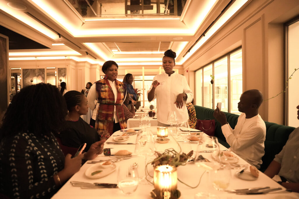 Kondokpo: Georgiana Viou and Nokx Majozi at Sofitel Cotonou 6 Chef Nokx Majozi and Chef Georgiana Viou explaining their first service to guests around a beautifully set table during the Kondokpo dinner at Sofitel Cotonou.