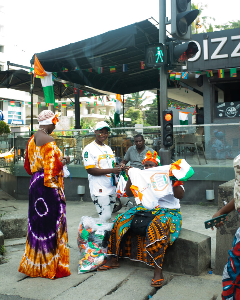 The Jersey Economy: Why Africa Is the Most Valuable Untapped Market in Sports Merchandise 3 African football fans in Côte d'Ivoire jerseys gathering at a local street event.