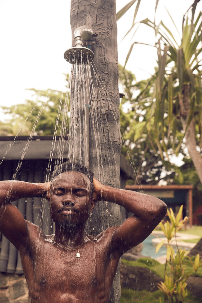 Writer Kofi Dotse at the outdoor shower at Omali Lodge, São Tomé 