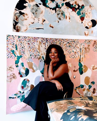 Woven Stories: 9 African Artists Shaping Contemporary Narratives Through Textiles 11 Portrait of contemporary African artist Modupeola Fadugba sitting before a vibrant, patterned artwork, highlighting themes of repetition and surface in African art.