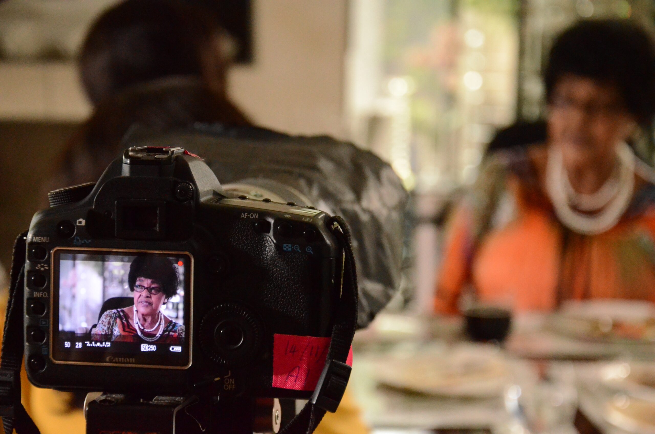 The Woman History Could Not Contain 4 Behind-the-scenes still showing Winnie Madikizela-Mandela framed in a camera viewfinder during the filming of The Trials of Winnie Mandela.