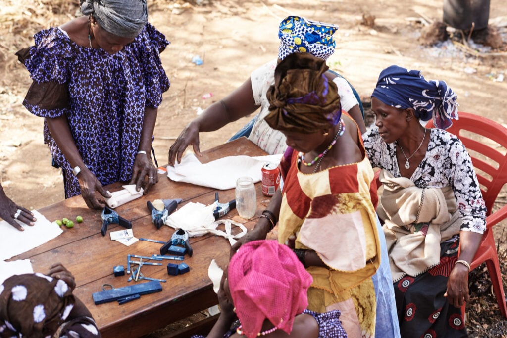 The Machine Can See You. It Still Can't Pay You. 2 Artisan tie-dyer at work in Modiya, Kindia, Republic of Guinea. Photograph by John Brown, courtesy of the Institute of African Textile.