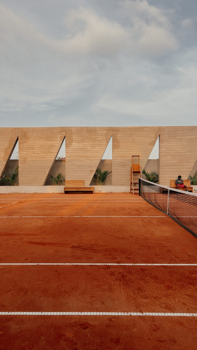 Backyard Community Club in Osu, Accra: rammed-earth tennis enclosure by DeRoche Projects