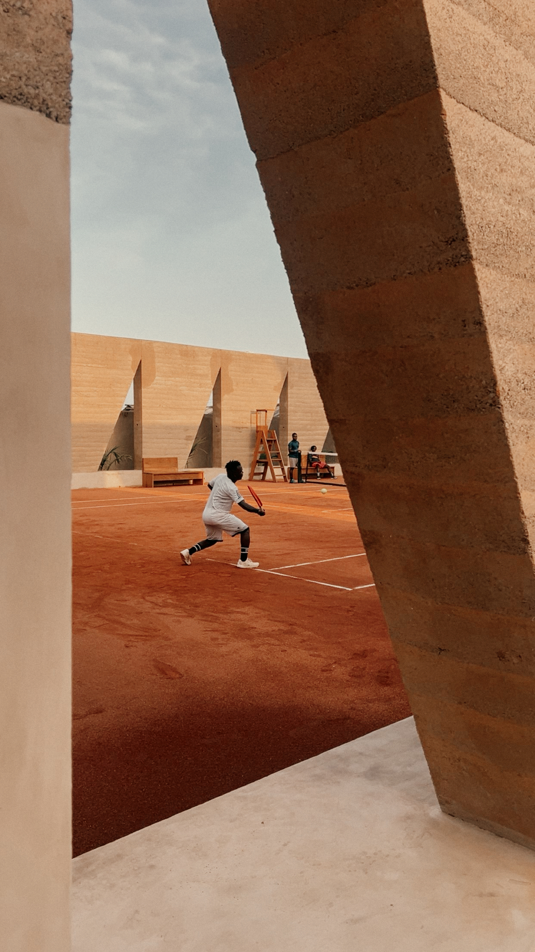 Young athletes on the clay court at Backyard Community Club, Osu, Accra