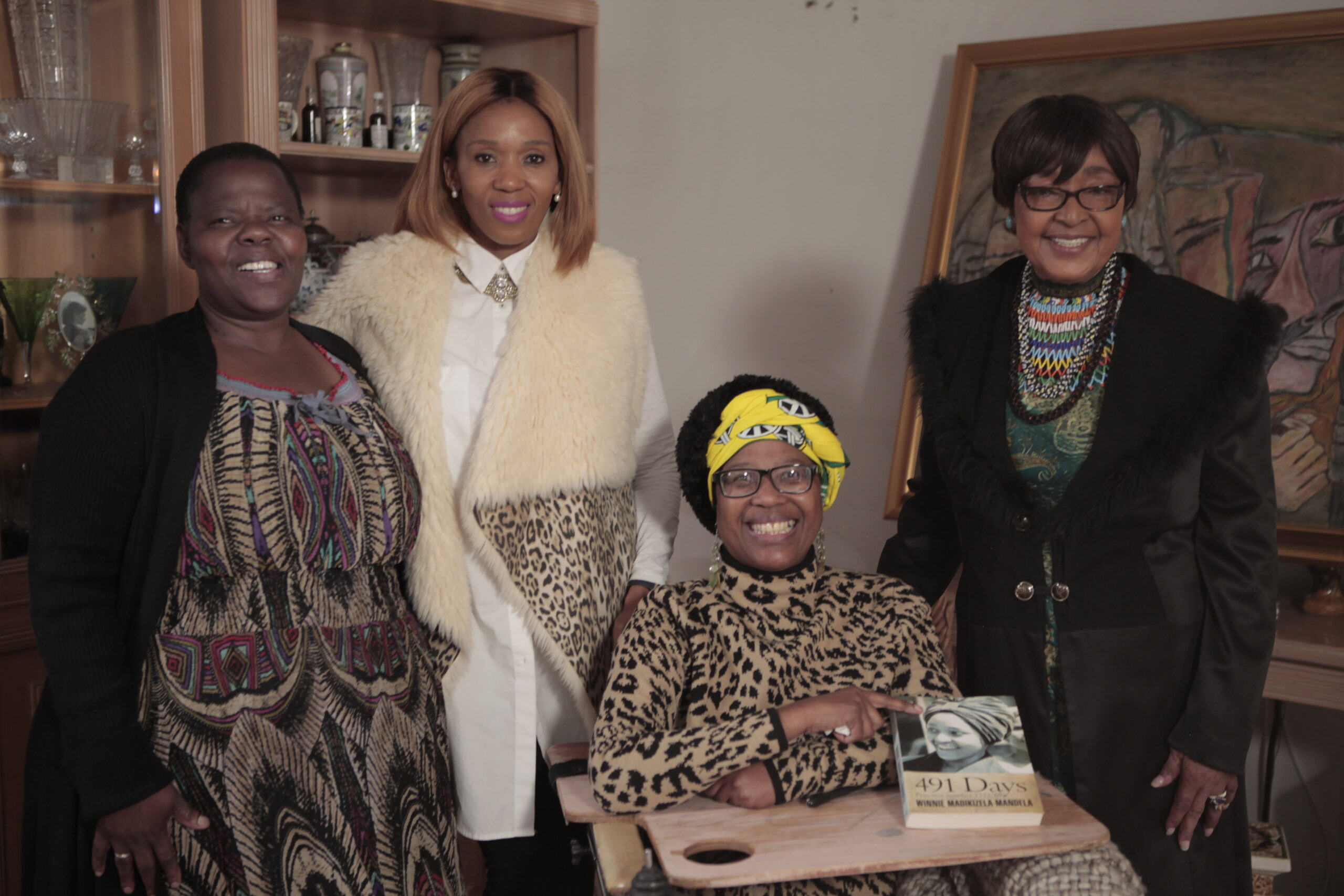 The Woman History Could Not Contain 1 Winnie Madikizela-Mandela seated with her granddaughters and a family member, holding a copy of 491 Days, the book based on the journal she kept in solitary confinement.