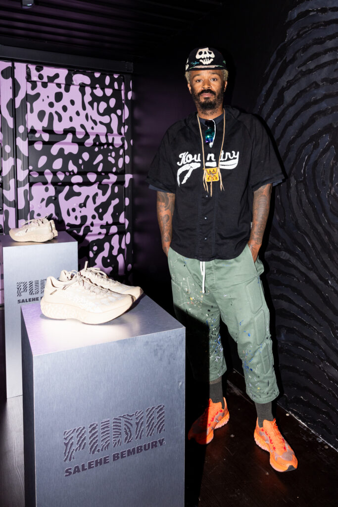Puma Brought the Continent to Downtown LA. The Postcards Were the Tell 7 Designer Salehe Bembury beside the Puma Velum 1 running shoe at the TRVL WEAR activation