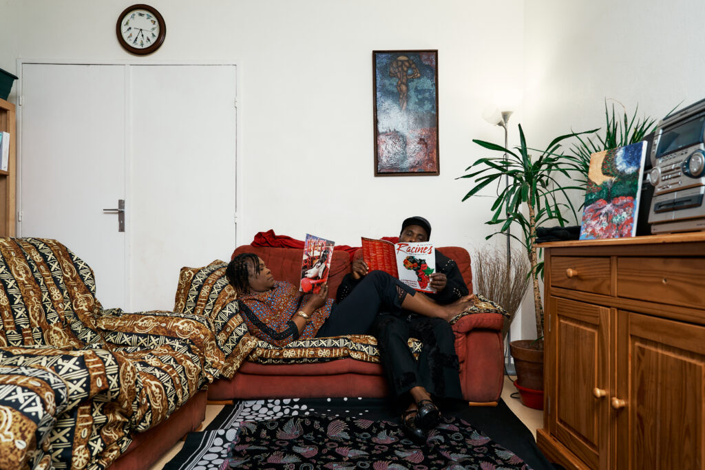 Two hands resting together against patterned fabric in Generational Love, a study of restrained affection