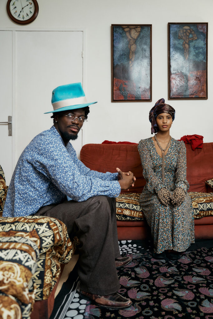 A young couple lean into each other in Michel Odouffan’s living-room set for Generational Love, their closeness showing despite being asked to hide it