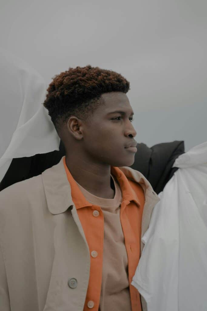 A young African man looks away thoughtfully, evoking the economic and emotional weight many men attach to the idea of marriage.