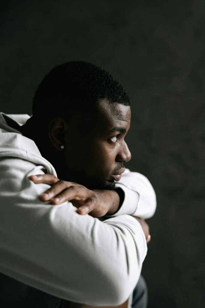 A contemplative African man sits alone, capturing the exhaustion and hesitation around commitment described in the story.