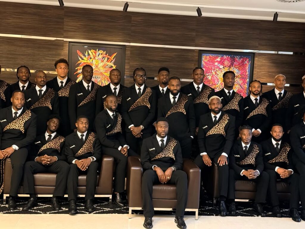 The DR Congo national football team, the Leopards, in matching black silk-crepe suits with leopard-print lapels on arrival at the 2026 World Cup.