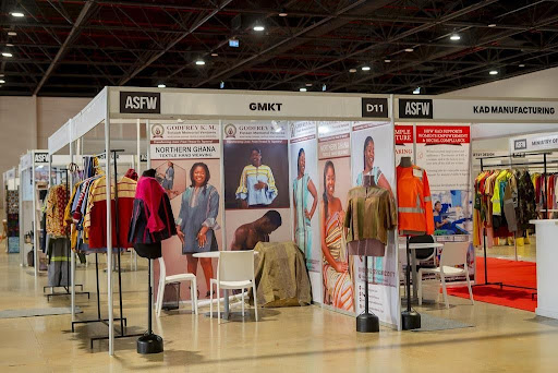 Africa Grows the Cotton. A Dakar Gathering Asks Who Profits. 2 Exhibition hall at ASFW Dakar 2026 filled with textile manufacturers, suppliers and fashion entrepreneurs from across Africa