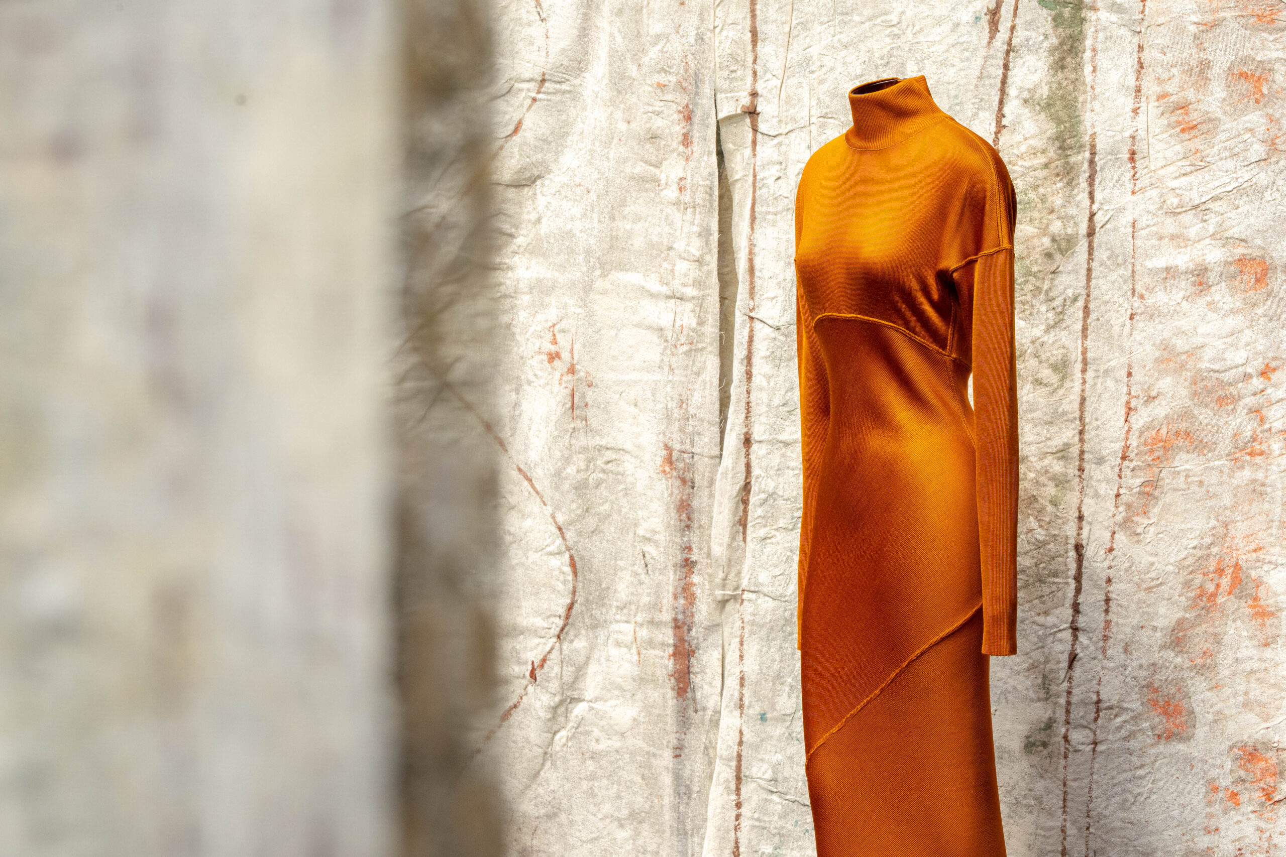 Azzedine Alaïa saffron acetate knit column dress, Autumn/Winter 1986, installation view in Paris