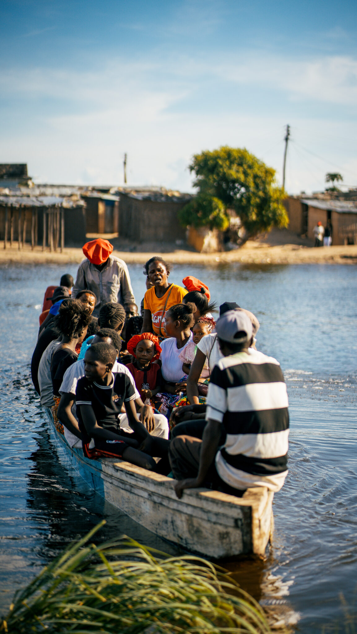 Six Days on the Zambezi: A Traveller's Guide to Kuomboka 9 Families travel by dugout canoe past a village on the Barotse floodplain, where water is the road, on the way to Kuomboka in Zambia.