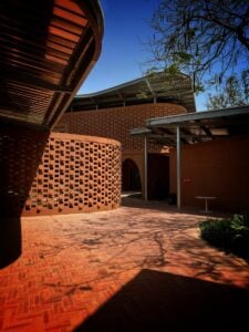 The Latest 29 Exterior of the Goethe-Institut Dakar, showing perforated laterite brick walls beneath a steel canopy