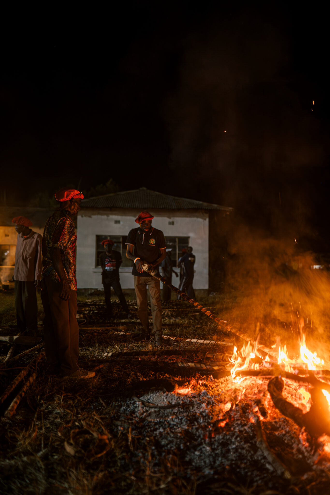 Six Days on the Zambezi: A Traveller's Guide to Kuomboka 3 A bonfire burns as men in red berets gather at Lealui for preparations two nights before the Kuomboka crossing in Barotseland, Zambia.