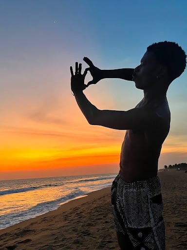 Why Artists Keep Returning to Grand-Popo 1 Art writer and curator Chisom Peter Job at the beach in Grand-Popo, Benin